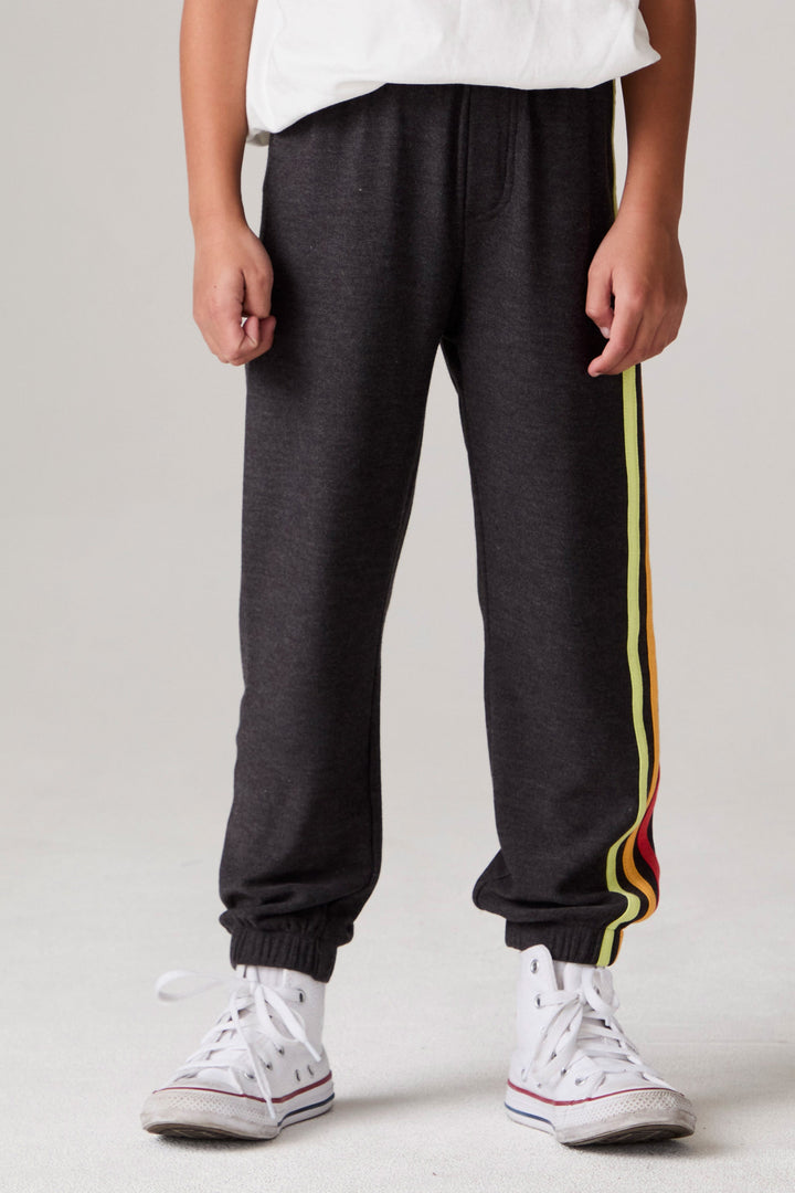 Model wearing Chaser's Vintage Black Stripe Boys Lounge Pants in Black with striped detailing, front view; pants only, coordinating tops sold separately