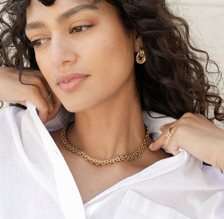 Close view of JLA Nicole gold statement chain necklace worn at the neckline