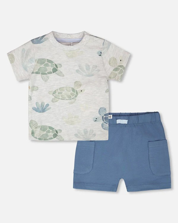 Children's t-shirt with turtle design and blue shorts on a white background