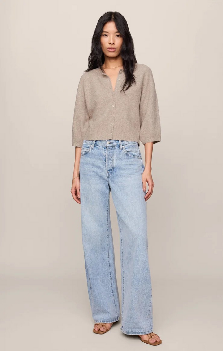 Woman wearing a beige shirt and light blue jeans against a plain background
Z supply