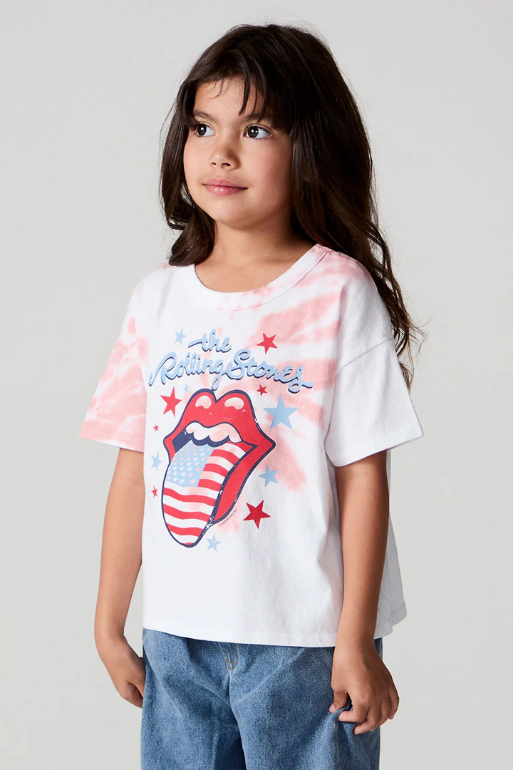 Young girl wearing a white t-shirt with Rolling Stones logo and design on a plain background