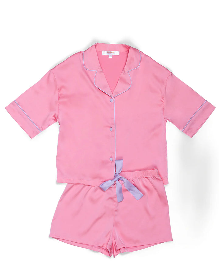 Pink pajama set with a bow detail on a white background