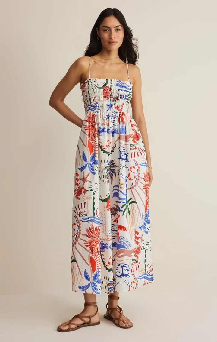 Woman wearing a colorful floral dress on a beige background z supply vacation coastal
