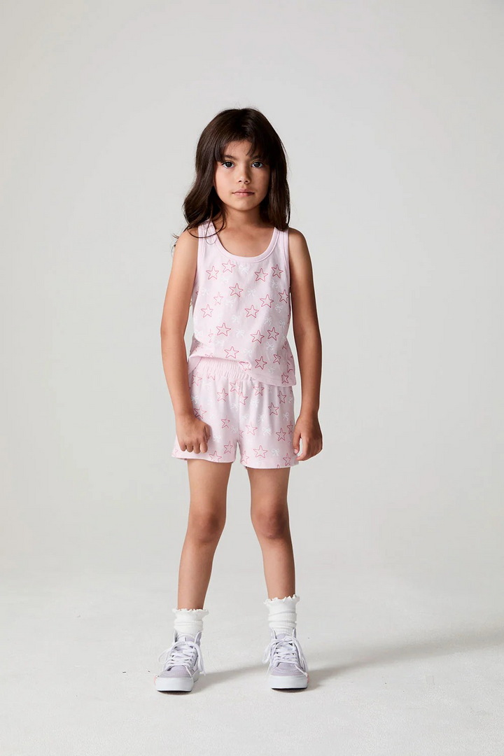 Young girl wearing a pink floral outfit with bows and stars chaser brand