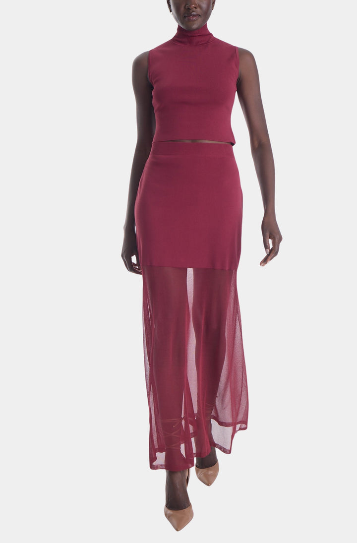 Karina Grimaldi Aitana Knit Set in Mulberry, sleeveless turtleneck top and sheer maxi skirt on model.
