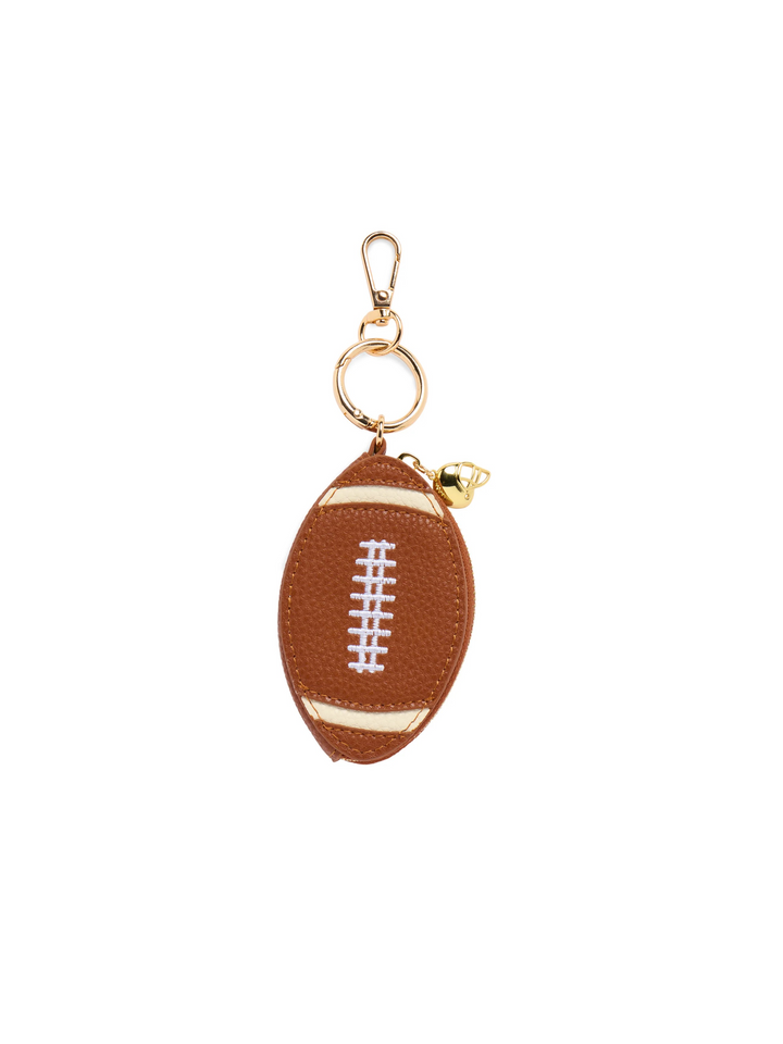 A football-shaped keychain pouch in brown faux leather with white laces and gold-tone hardware, shown on a plain white background.