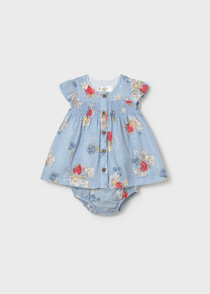 Baby dress with floral pattern on a light gray background