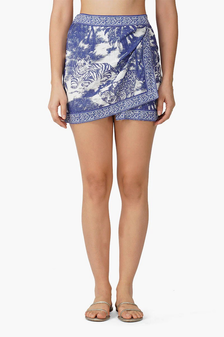Person wearing a blue and white patterned skirt on a white background